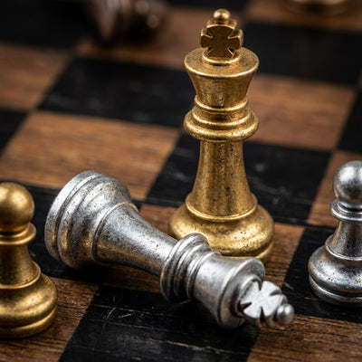 Chess wall art, a gold king standing over a fallen silver king