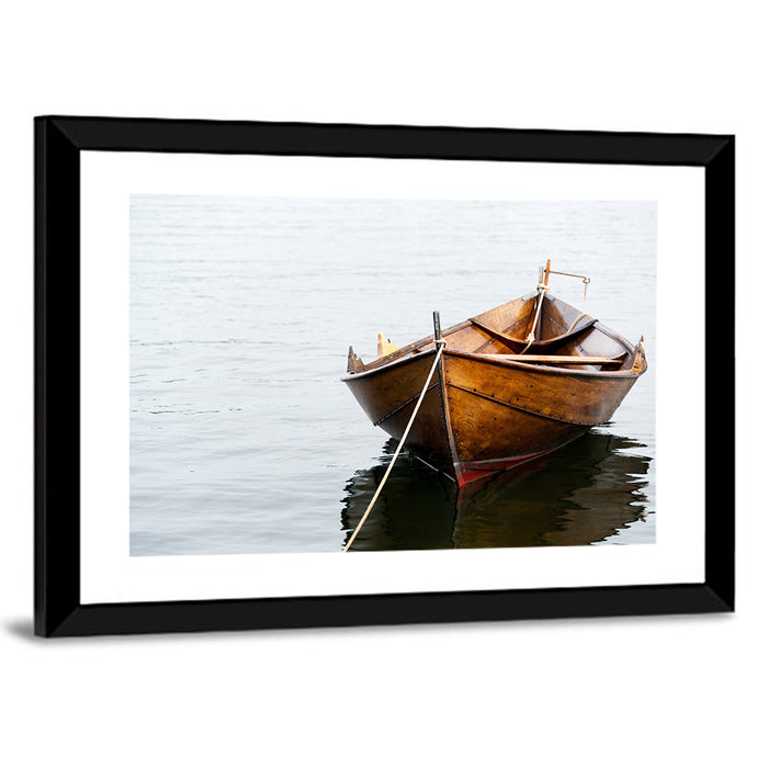 Tethered Wooden Rowboat on Calm Water Wall Art as a framed print