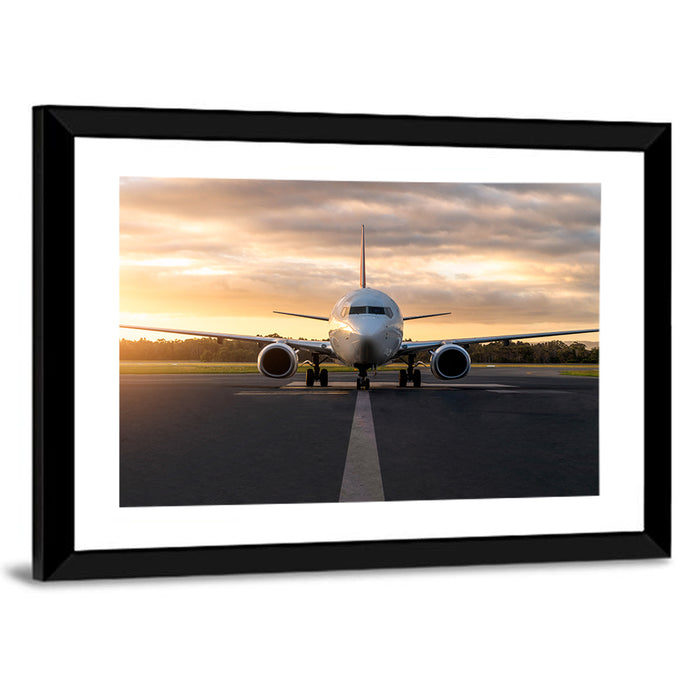 Front Facing Airplane on Runway at Sunset Wall Art as a framed print