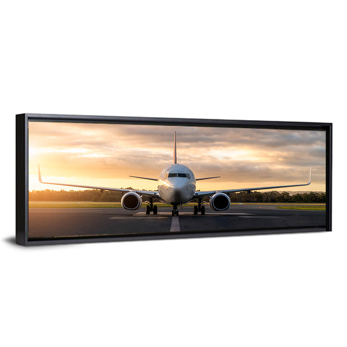 Front Facing Airplane on Runway at Sunset Wall Art as a framed canvas