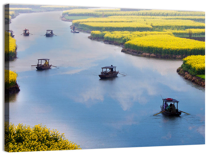 Spring River Rowboats in Rapeseed Fields Wall Art as a canvas print