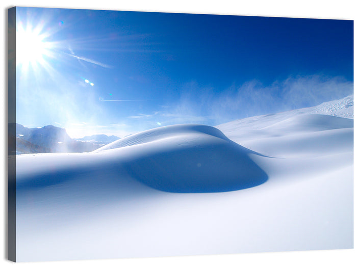 Sunlit Snow Dune Under Blue Sky Wall Art as a canvas print