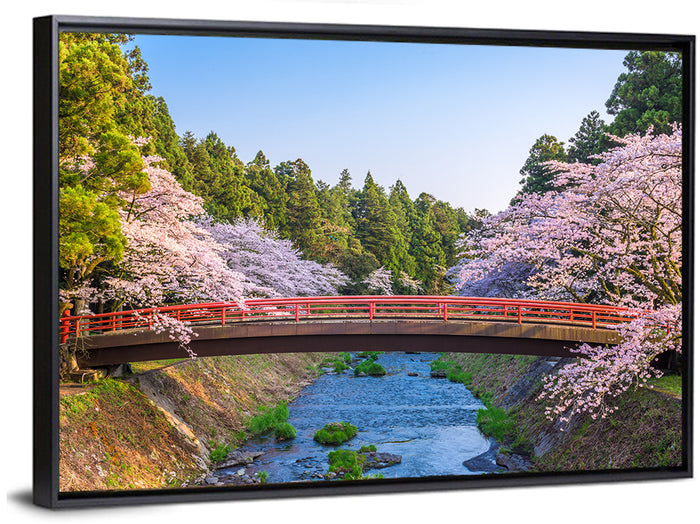Arched Red Bridge with Cherry Blossoms Wall Art as a framed canvas