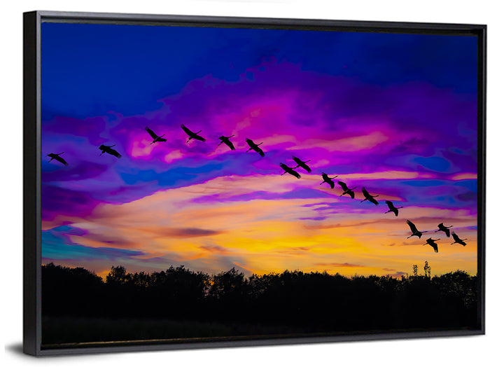 Silhouetted Cranes at Dusk Wall Art as a framed canvas