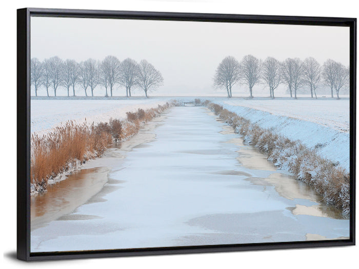 Frozen Canal with Bare Trees Wall Art as a framed canvas