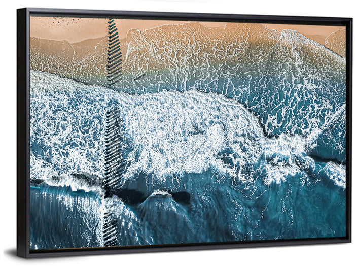 Aerial Pier Pilings Over Surf Wall Art as a framed canvas
