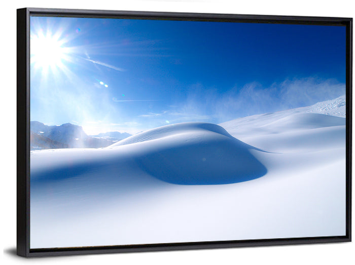 Sunlit Snow Dune Under Blue Sky Wall Art as a framed canvas