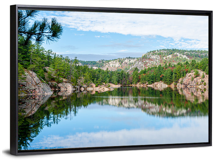Mirror-quiet Lake and Pines Wall Art as a framed canvas