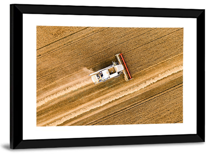 Aerial Combine Over Wheat Field Wall Art as a framed print