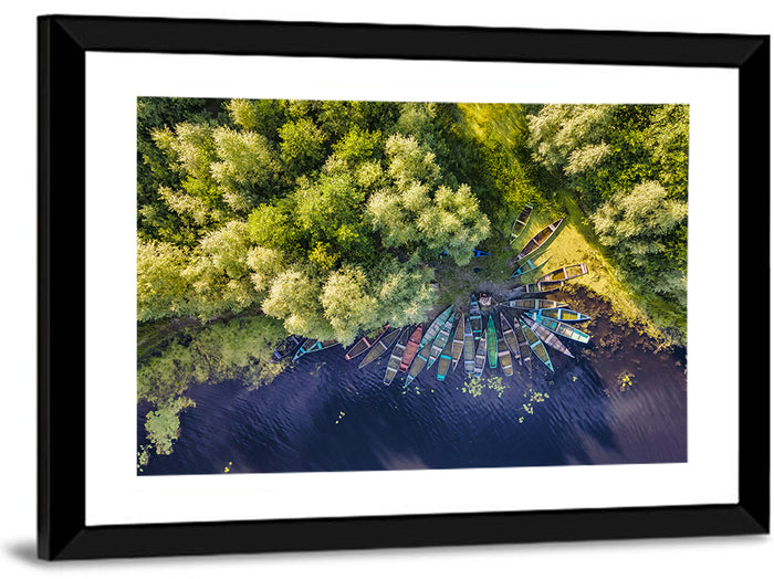 Cluster of Boats Along Forest Shore Wall Art as a framed print