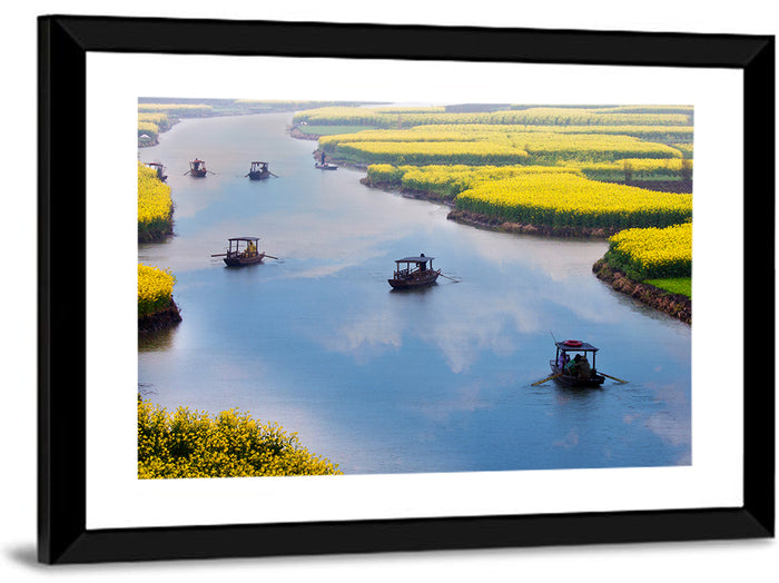 Spring River Rowboats in Rapeseed Fields Wall Art as a framed print