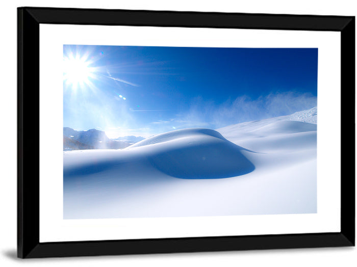 Sunlit Snow Dune Under Blue Sky Wall Art as a framed print