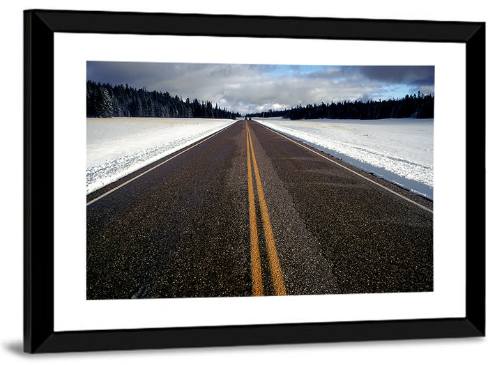 Winter Road Through Pine Forest Wall Art as a framed print