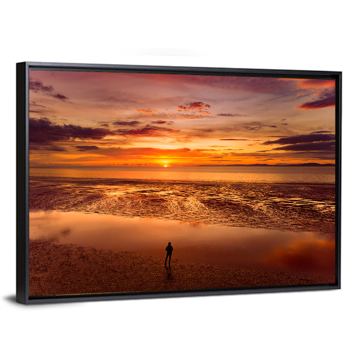 Solitary Figure on Sunset Shore Wall Art as a framed canvas