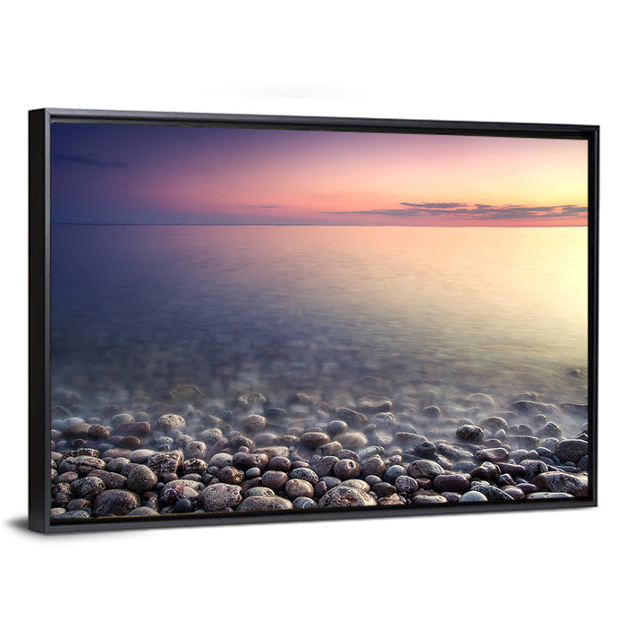 Pebbled Shore Sunset Wall Art as a framed canvas