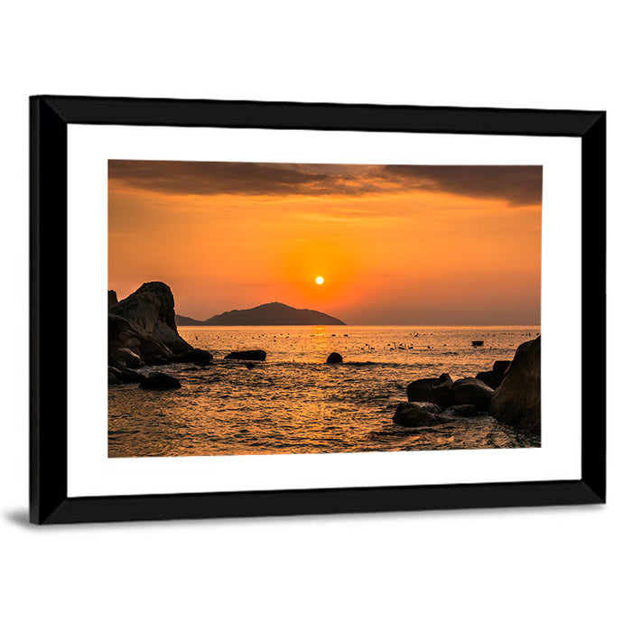 Orange Sunrise Over Rocky Coast Wall Art as a framed print