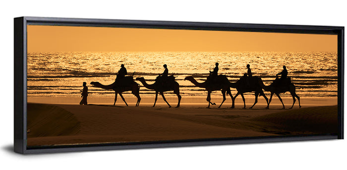 Camel Caravan Silhouette on Wet Sand Wall Art as a framed canvas
