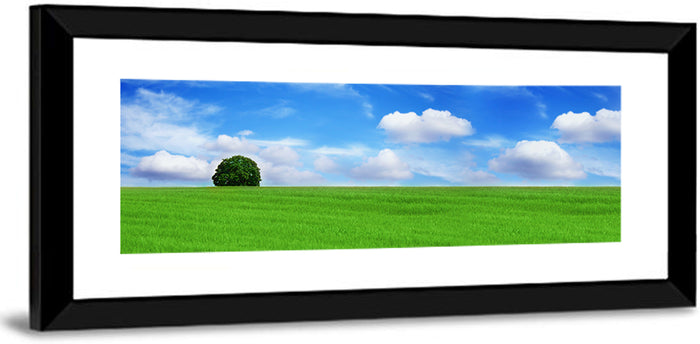 Solitary Tree Over Green Meadow Wall Art as a framed print
