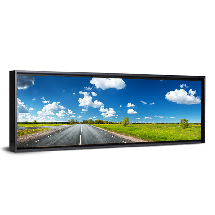 Asphalt Road Through Meadow Wall Art as a framed canvas
