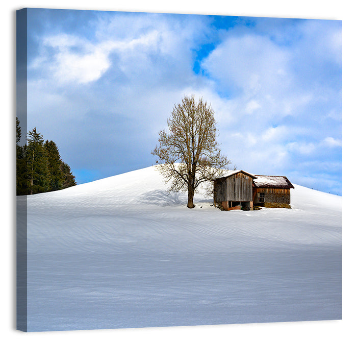 Rustic Barn on a Snowy Hill Wall Art as a canvas print