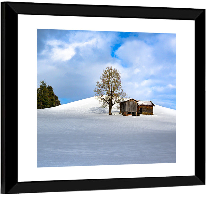 Rustic Barn on a Snowy Hill Wall Art as a framed print