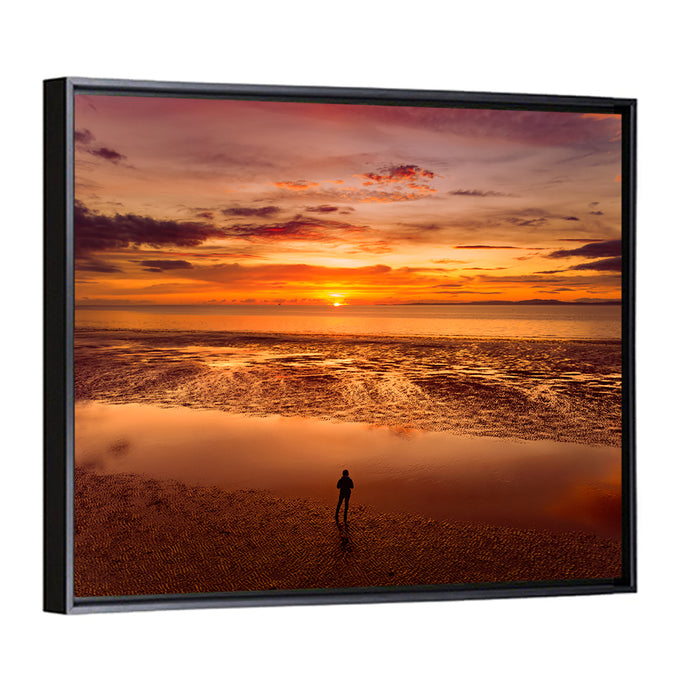 Solitary Figure on Sunset Shore Wall Art as a framed canvas