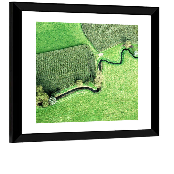 Meandering Stream Over Farmland Wall Art as a framed print