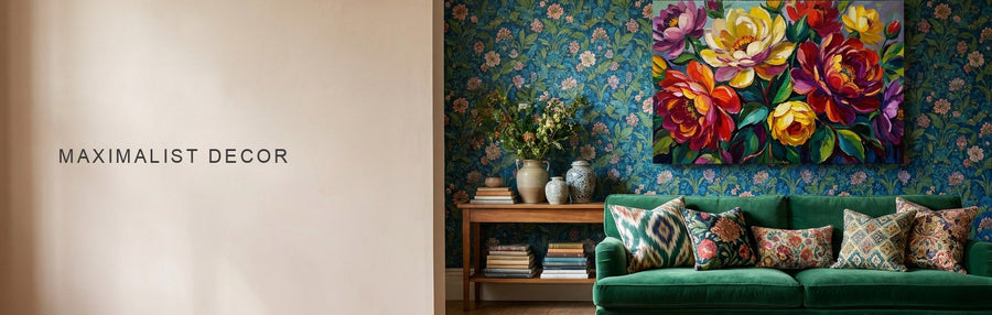 Maximalist decor in a living room with patterned wallpaper, an emerald velvet sofa, many cushions and a bold colorful floral canvas