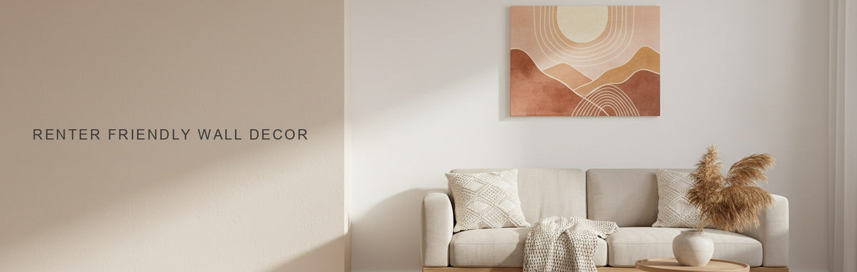 Renter friendly wall decor in a white-walled apartment living room: a boho sun and hills canvas leaning above a jute rug