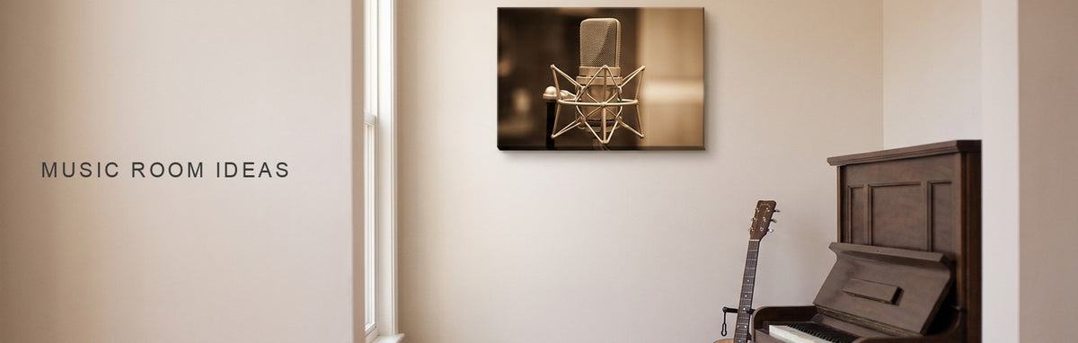 Music room ideas: a room with an upright piano and an acoustic guitar on a stand beneath a vintage studio microphone canvas in warm light
