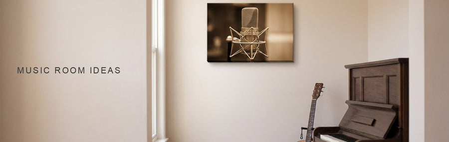 Music room ideas: a room with an upright piano and an acoustic guitar on a stand beneath a vintage studio microphone canvas in warm light