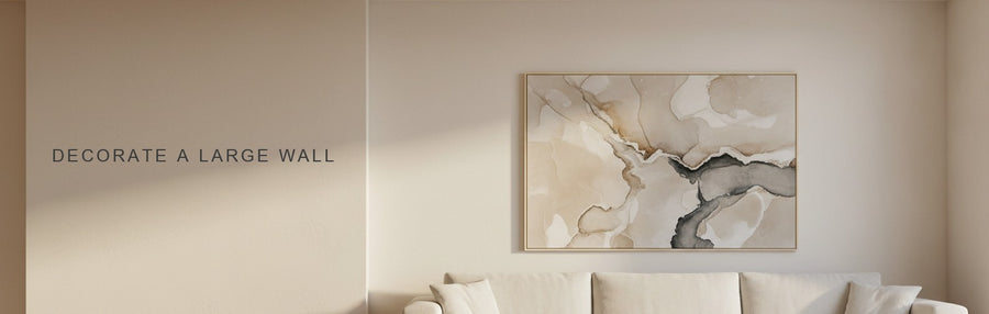 How to decorate a large wall: a double height living room with a long sofa under a large neutral abstract in sand and charcoal