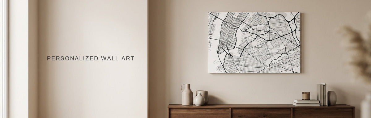 Personalized wall art in a warm living room: a minimalist black and white city street map canvas above a walnut console