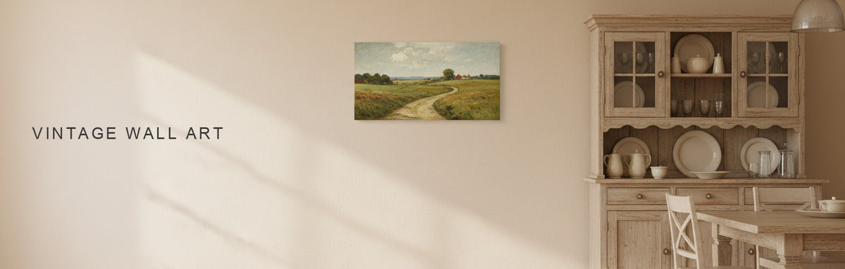 Vintage wall art in a farmhouse dining room with a wooden hutch and a vintage farm lane landscape in muted greens
