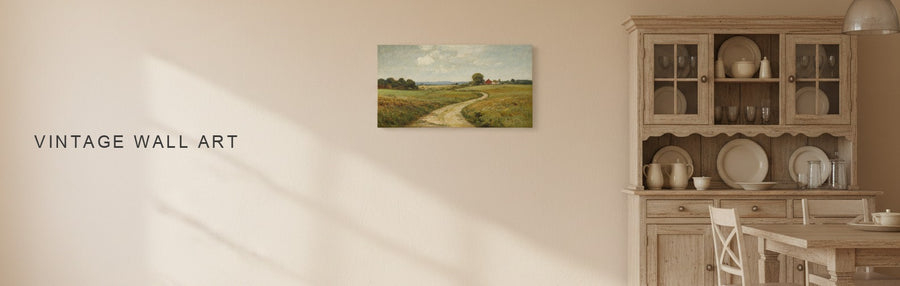Vintage wall art in a farmhouse dining room with a wooden hutch and a vintage farm lane landscape in muted greens