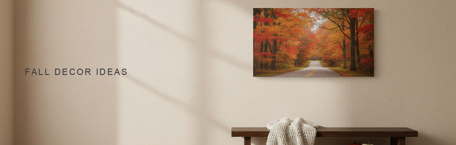 Fall decor ideas in an entryway: a bench with a wool throw and mini pumpkins under a country road through red and orange maples