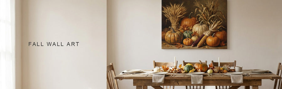Thanksgiving wall decor in a farmhouse dining room: a harvest still life of pumpkins and wheat above a long wooden table set for Thanksgiving