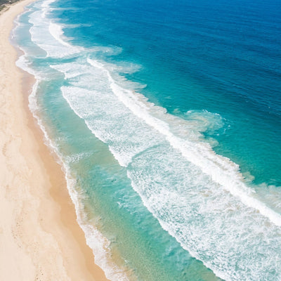 Coastal wall art, aerial view of a sandy beach with white surf and turquoise water