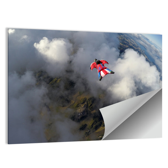 Red Wingsuit Skydiver Over Clouds Wall Art as a poster print