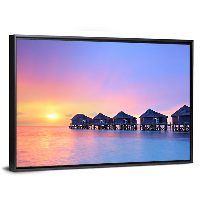 Maldives Sunset Over Water Bungalows Wall Art as a framed canvas