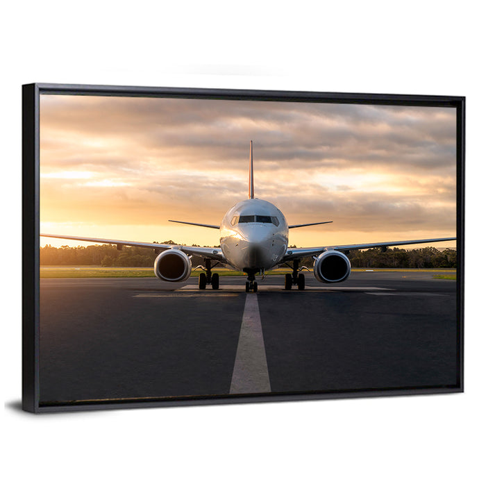Front Facing Airplane on Runway at Sunset Wall Art as a framed canvas