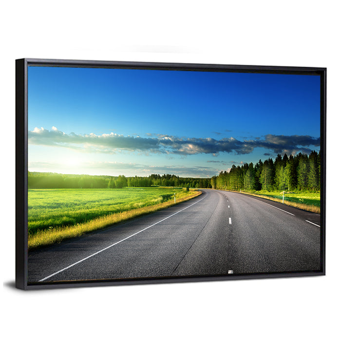 Curved Asphalt Road Through Forest Wall Art as a framed canvas