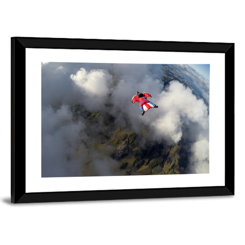 Red Wingsuit Skydiver Over Clouds Wall Art