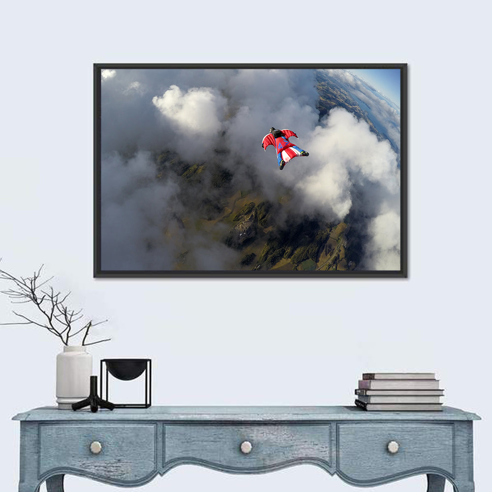 Red Wingsuit Skydiver Over Clouds Wall Art