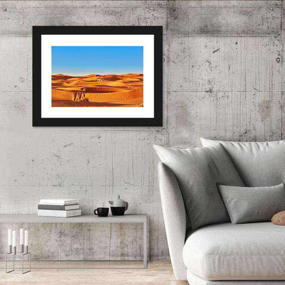 Sunlit Sahara Dunes with Camel Caravan Wall Art in a room, landscape