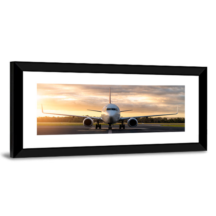 Front Facing Airplane on Runway at Sunset Wall Art as a framed print