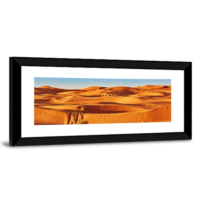 Sunlit Sahara Dunes with Camel Caravan Wall Art as a framed print