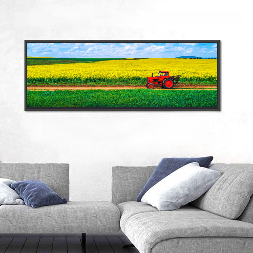 Red Tractor Over Yellow Rapeseed Field Wall Art in a room, panoramic