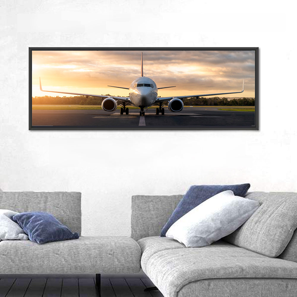 Front Facing Airplane on Runway at Sunset Wall Art in a room, panoramic