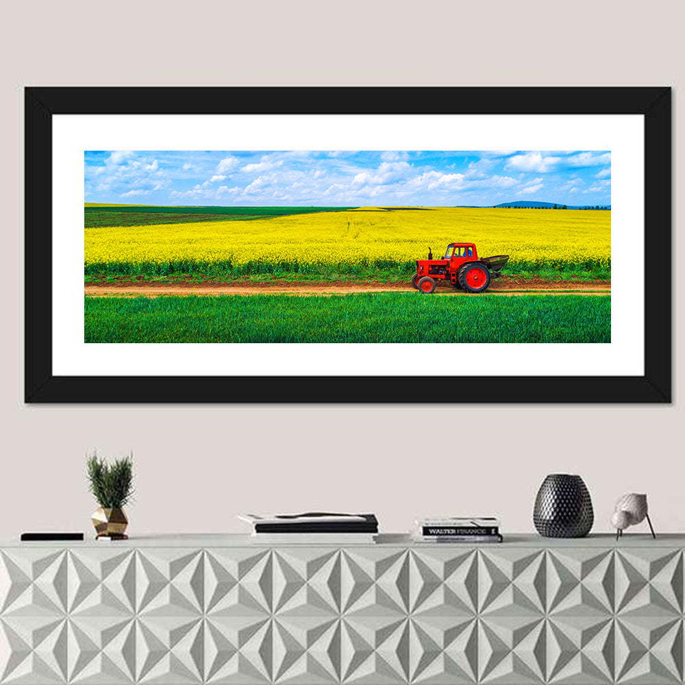 Red Tractor Over Yellow Rapeseed Field Wall Art in a room, panoramic